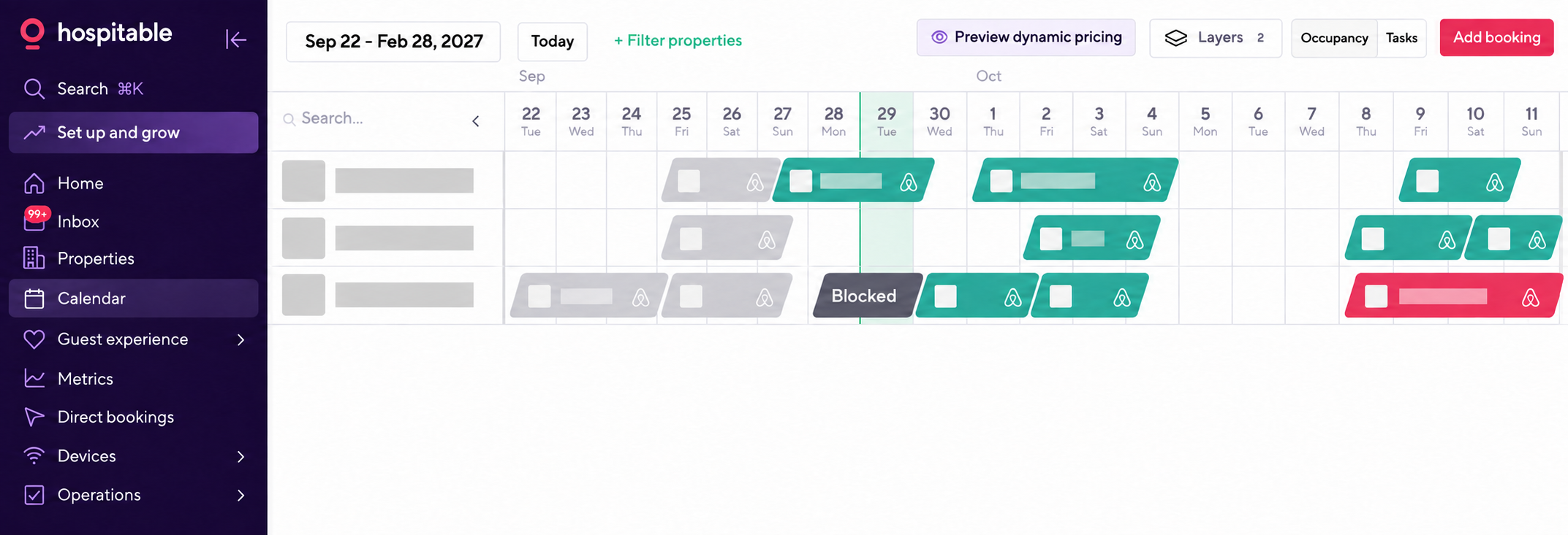 Redacted Hospitable calendar showing reservations centralized across multiple vacation rentals