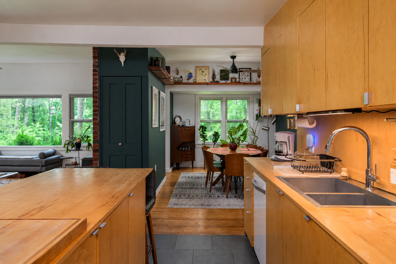 Zevo Flying Insect Trap glowing blue beside the sink in a vacation-rental kitchen